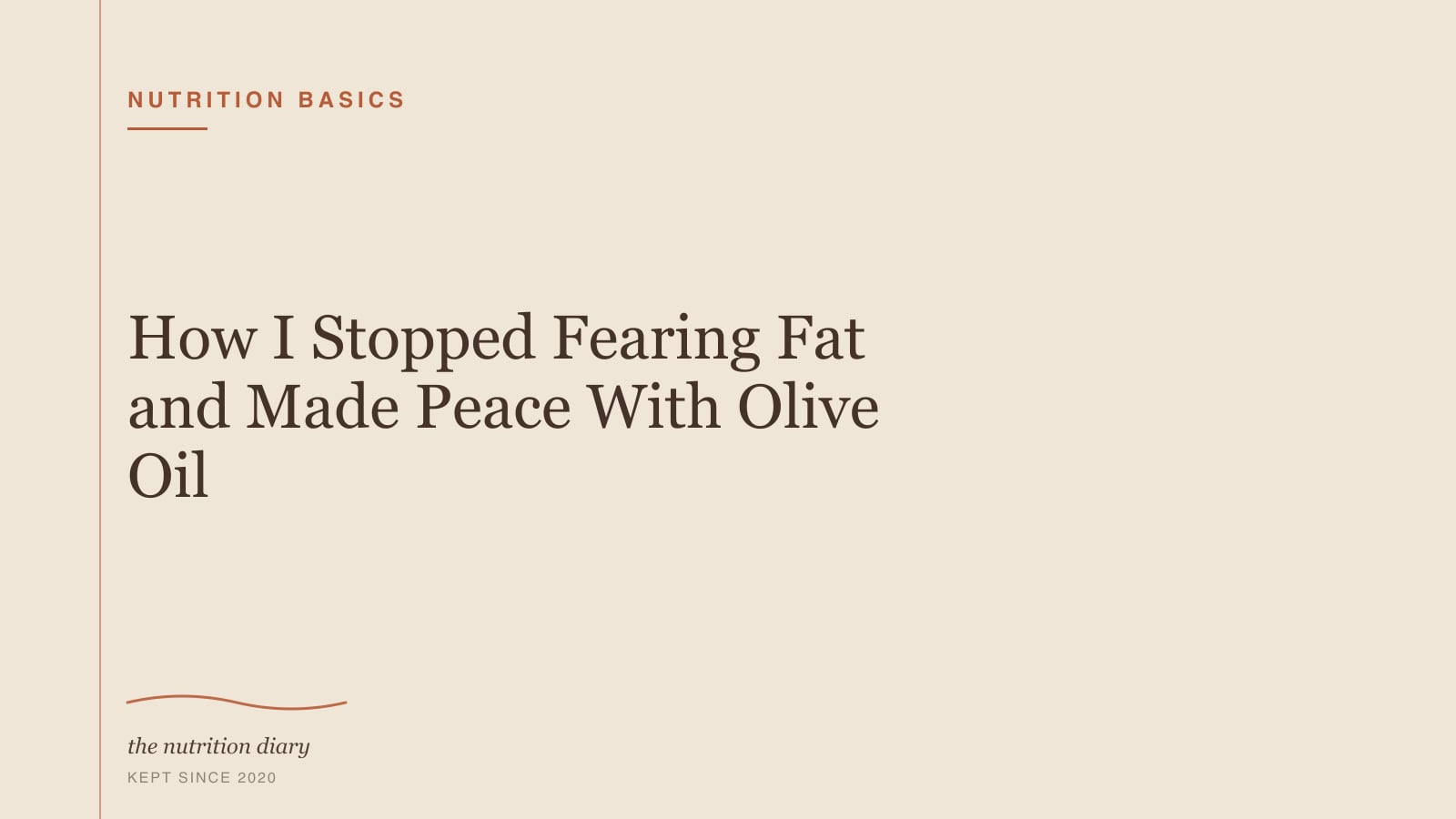 A small dish of olive oil, a halved avocado and a handful of walnuts on a wooden board