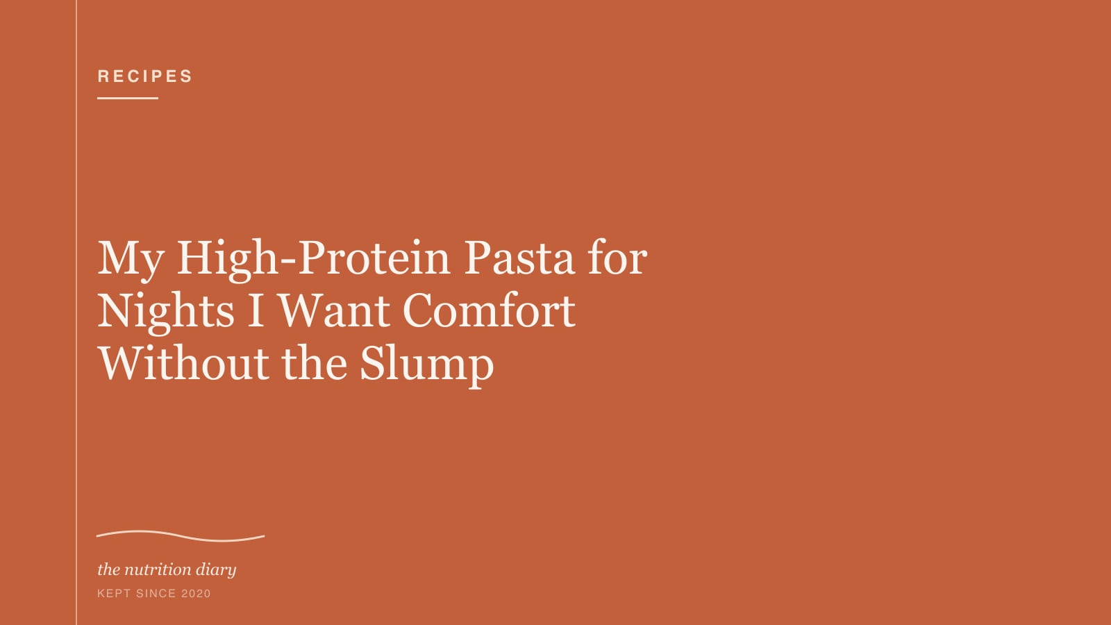 A bowl of creamy pasta with spinach and a sprinkle of black pepper on top